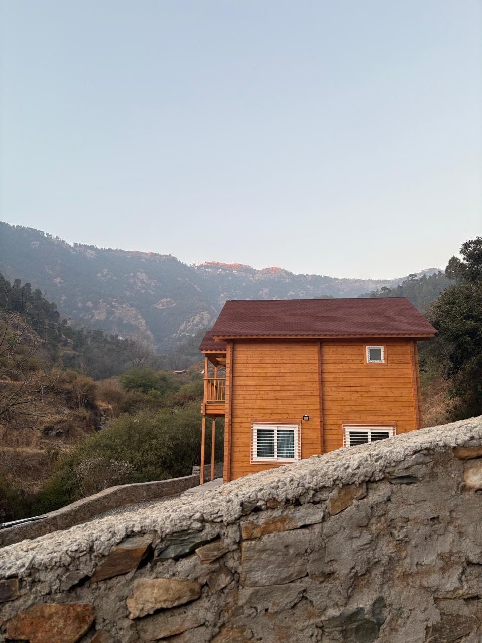 The chalet from the side with mountain views in the distance