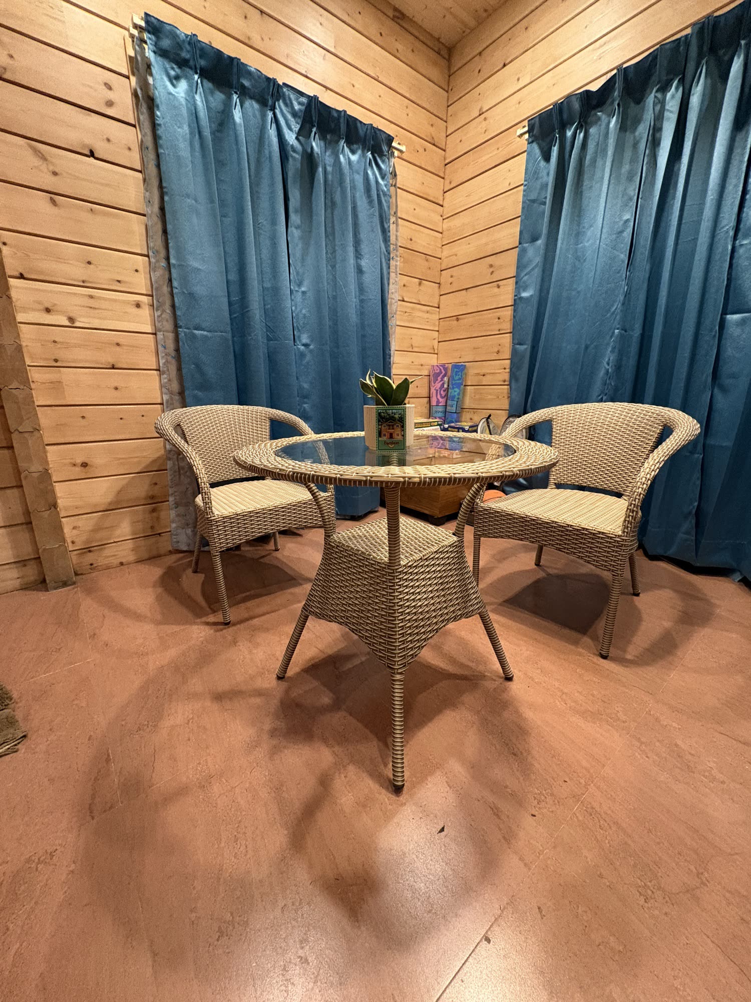 Cozy dining nook with rattan chairs and pine wood walls
